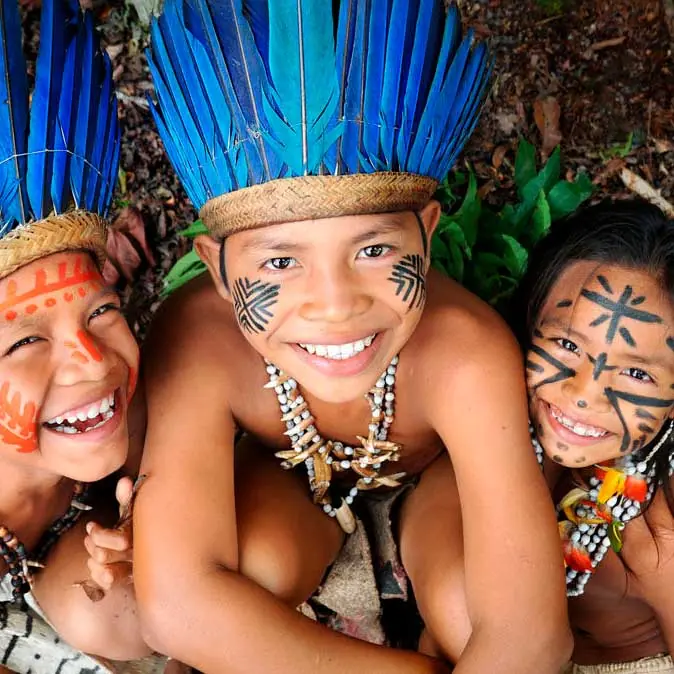 Indigenous children by the Amazon River, lifestyle of Brazils native peoples in the rainforest`