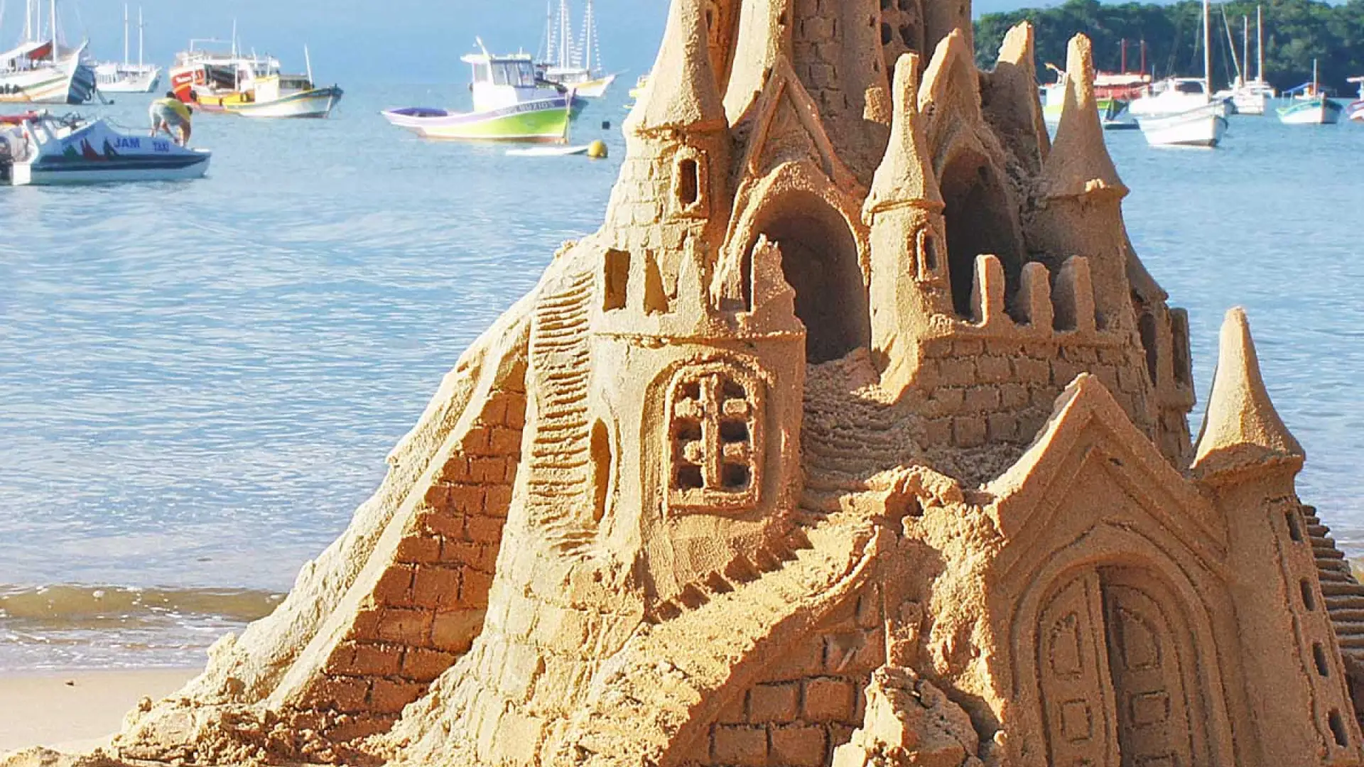 Sandcastles on Buzios beach in Brazil, white sand and the ocean