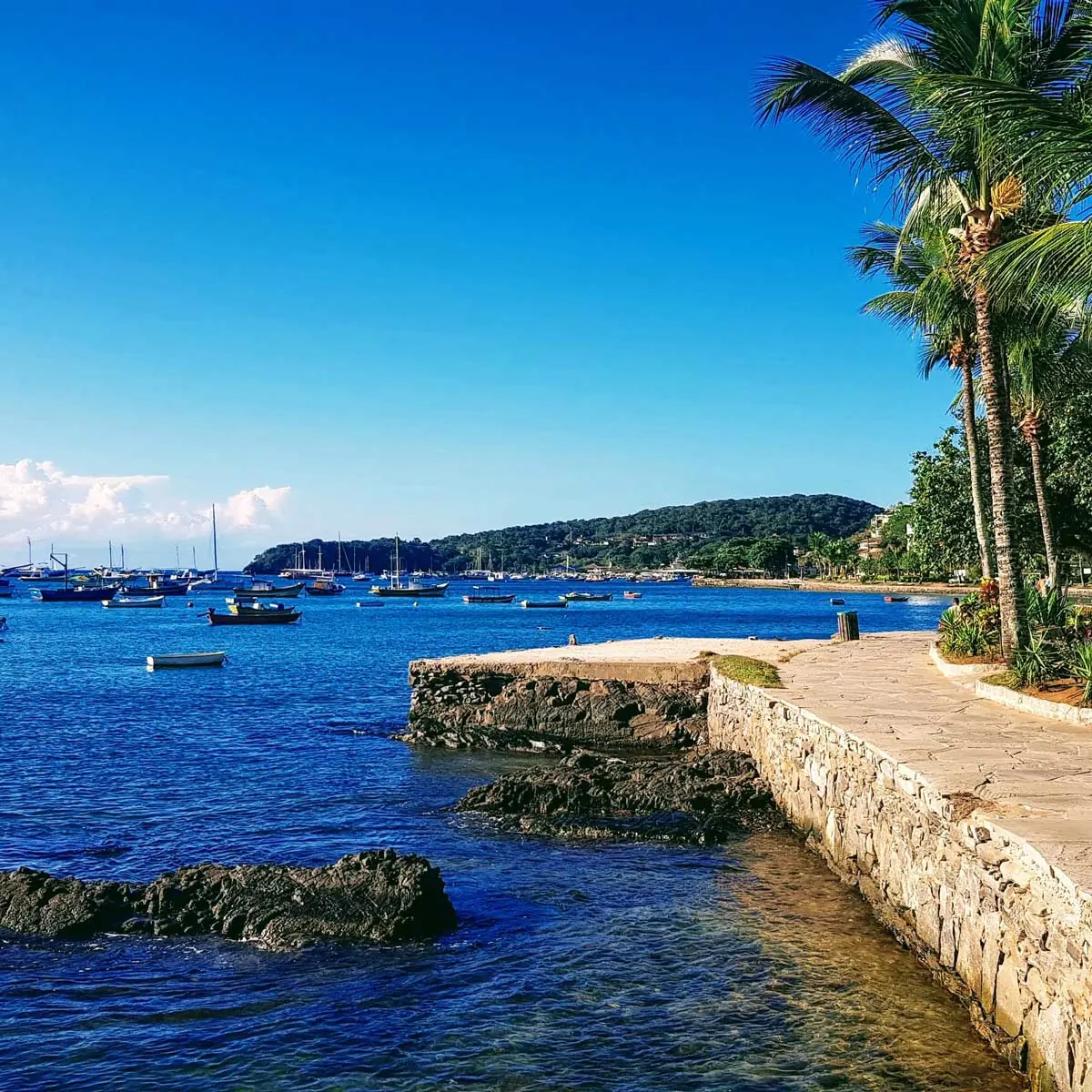 Buzios waterfront in Brazil, yachts and ocean, evening lights of the resort