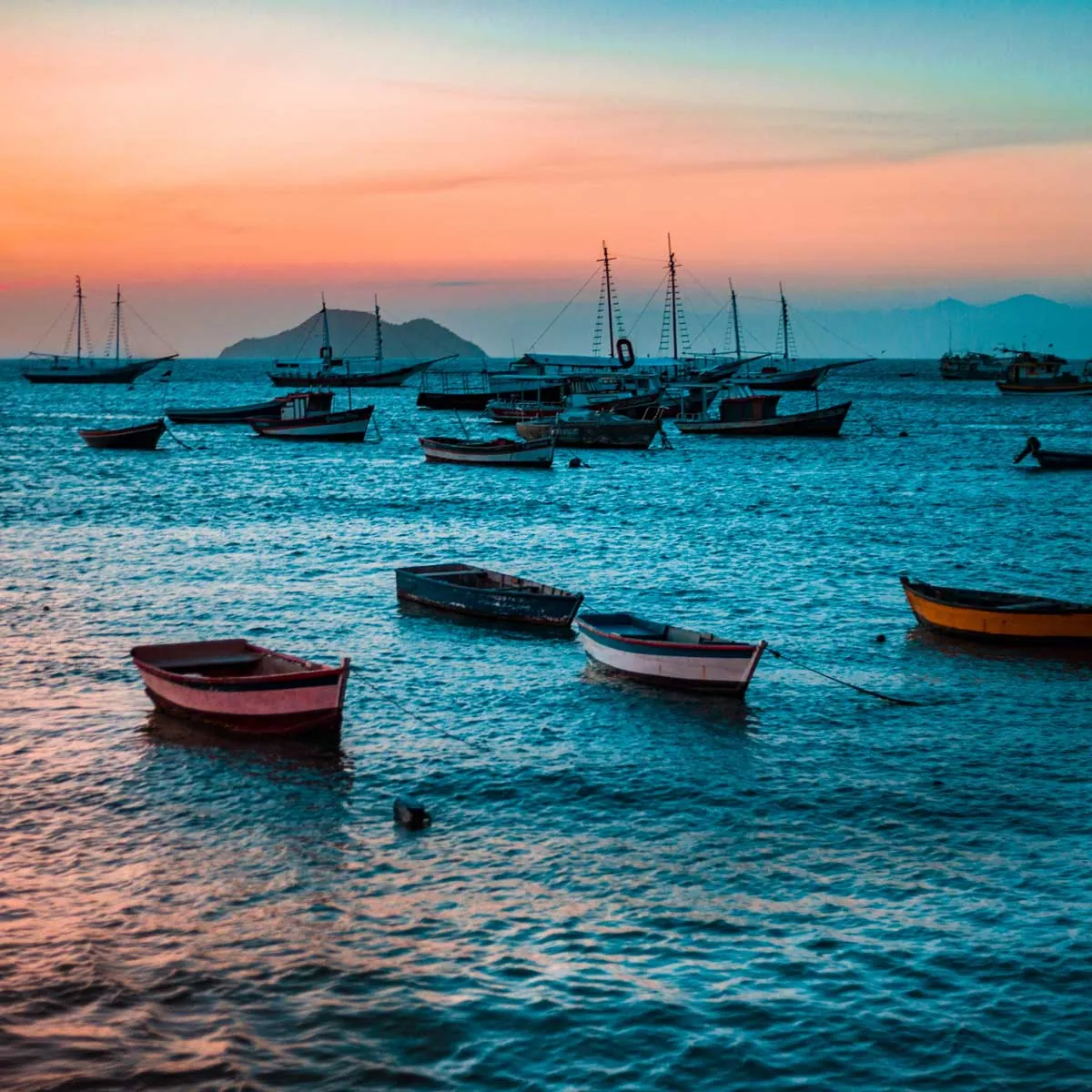 Calm ocean and yachts at sunset in Buzios, romantic evening in Brazil