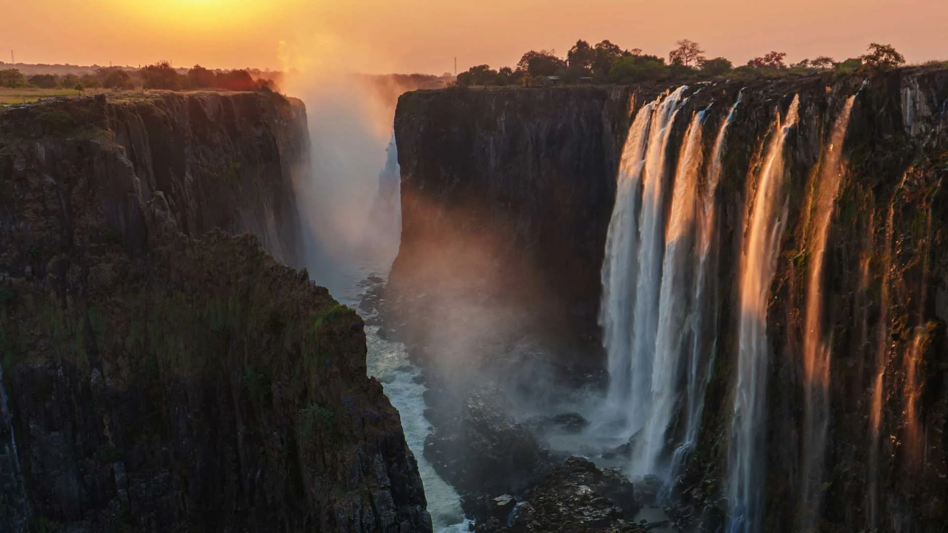 Iguazu Falls at sunset, Brazil and Argentina, golden light over cascades