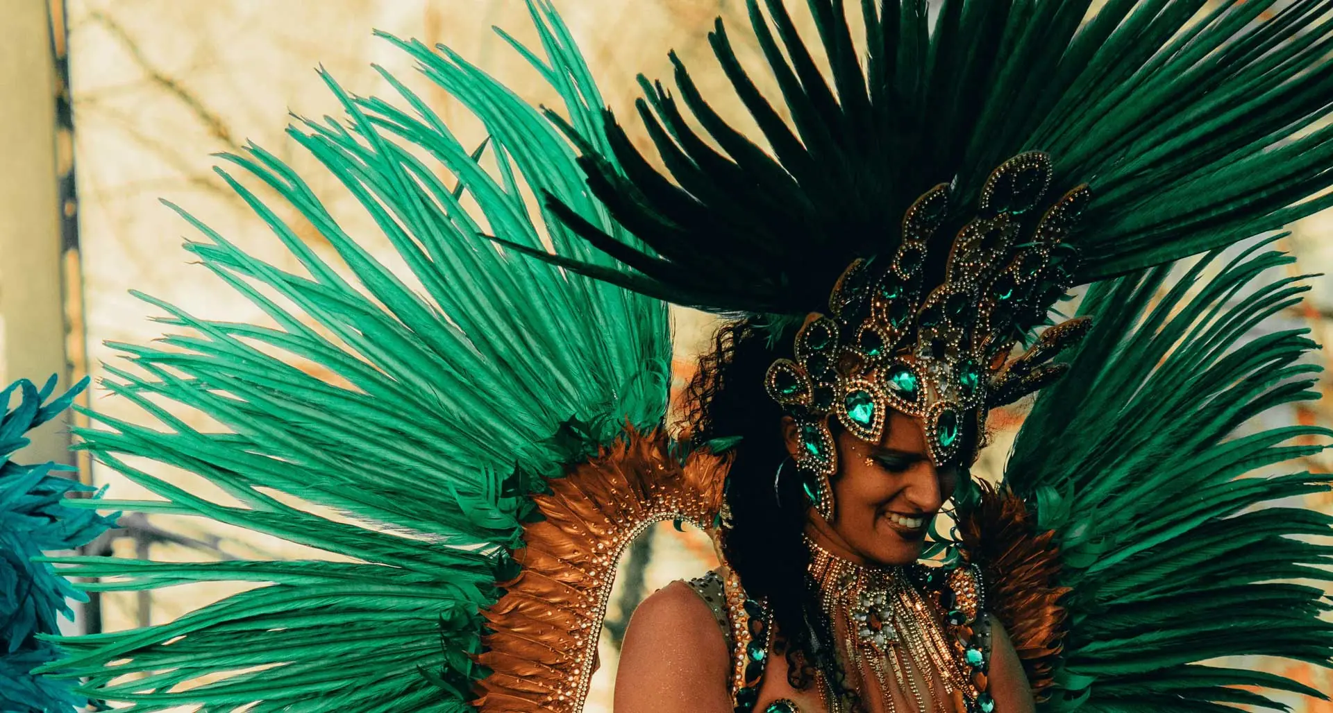 Girl in a carnival costume with bright green feathers in Rio