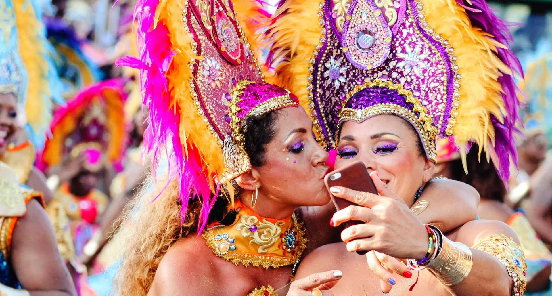 Happy girls at Rio Carnival, carnival costumes, feathers and samba