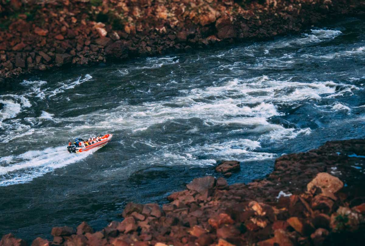 Macuco Safari boat approaching Iguazu Falls, getting soaked under the waterfall – adventure tour