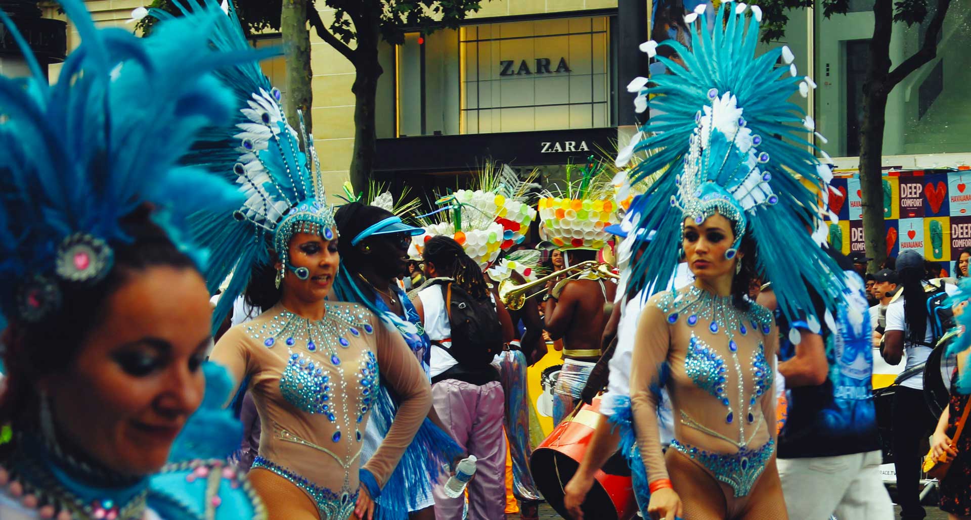 Girls in feathered costumes at Rio Carnival, dancing and samba school parade