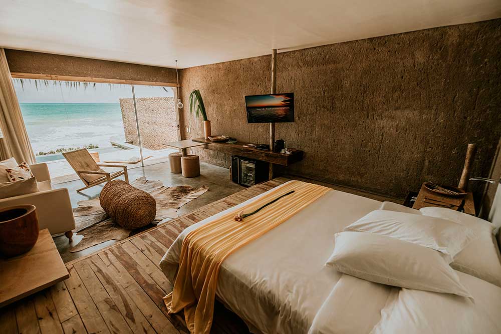 Kenoa eco-chic room interiors, stone and wood with panoramic ocean views