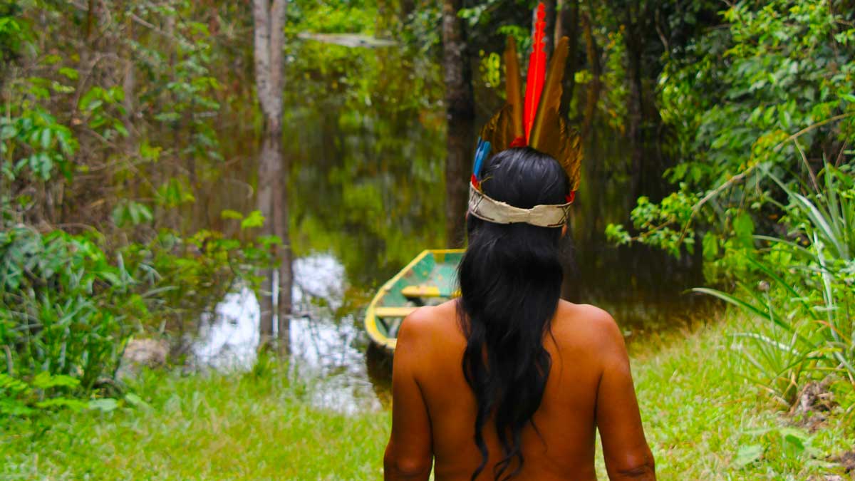 Native Indian Walking Through Amazon Rainforest Iquitos Peru