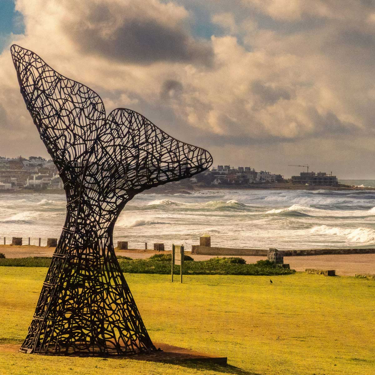 Mermaid tail sculpture on rocks at Punta del Este, Uruguay ocean artwork