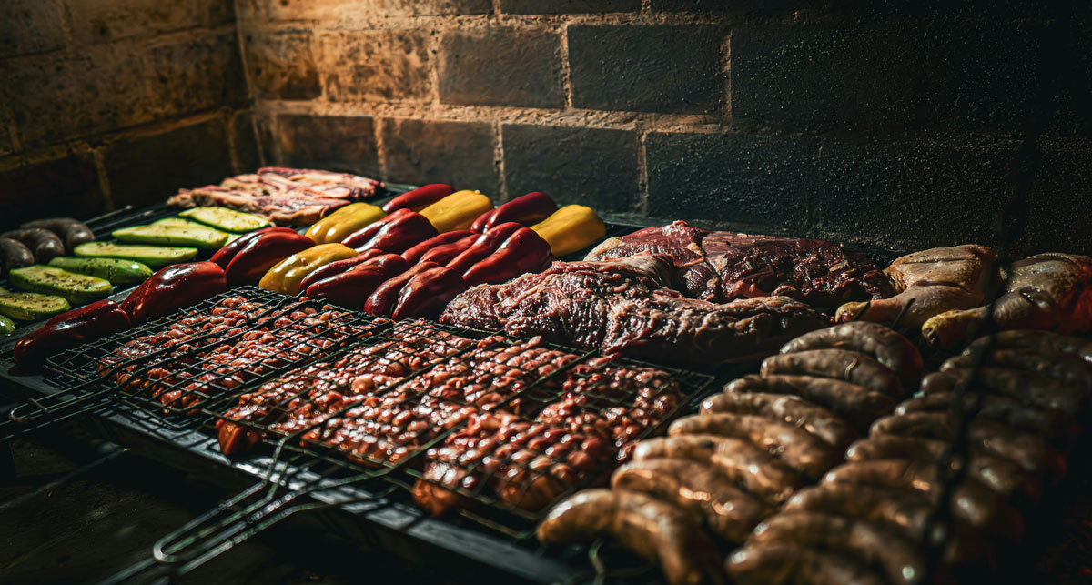Traditional Uruguayan asado, grilled meat and vegetables over a wood fire
