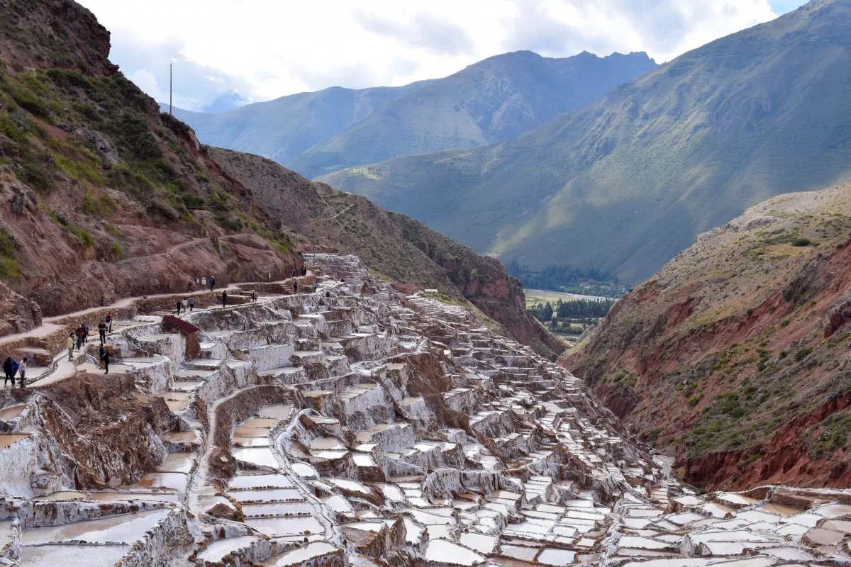 The Maras salt terraces in the Sacred Valley, with the Andes mountains behind.