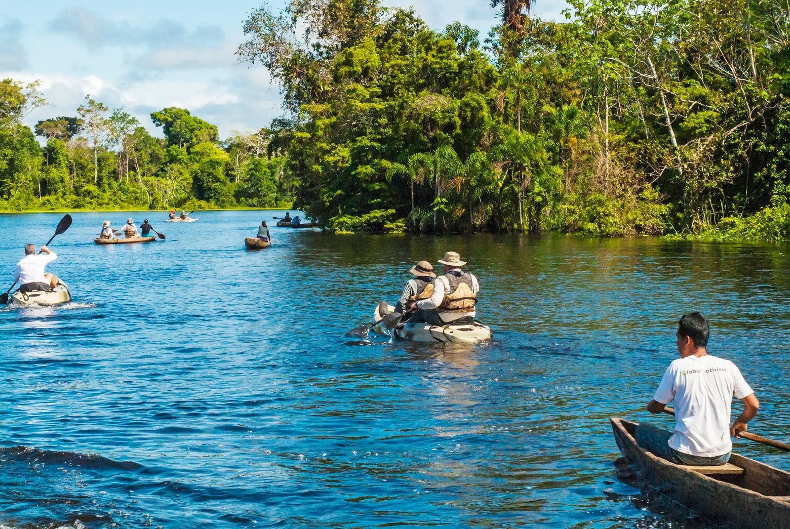 Small canoes on a forested waterway near Iquitos, Peru.