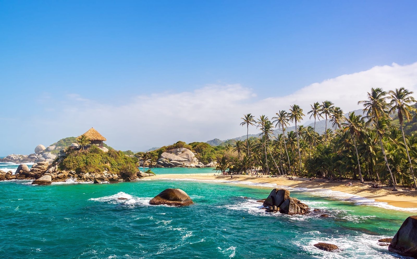 Rocky, palm-lined Caribbean coastline in Colombia.