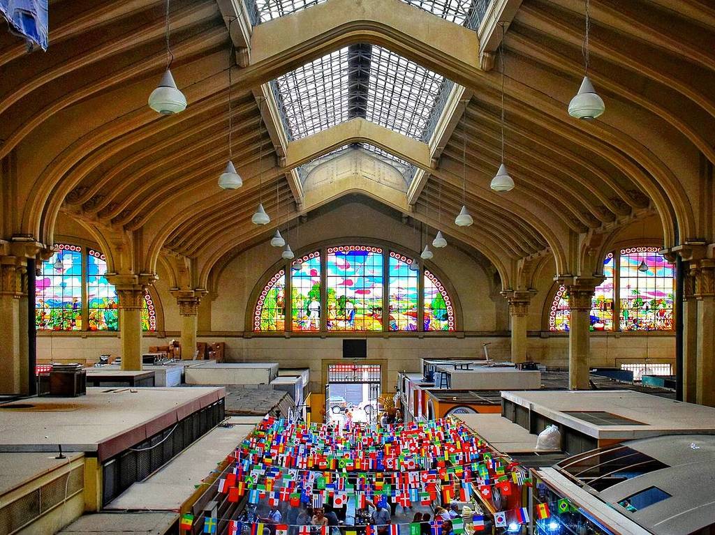 Interior of São Paulo Municipal Market with stained-glass windows.