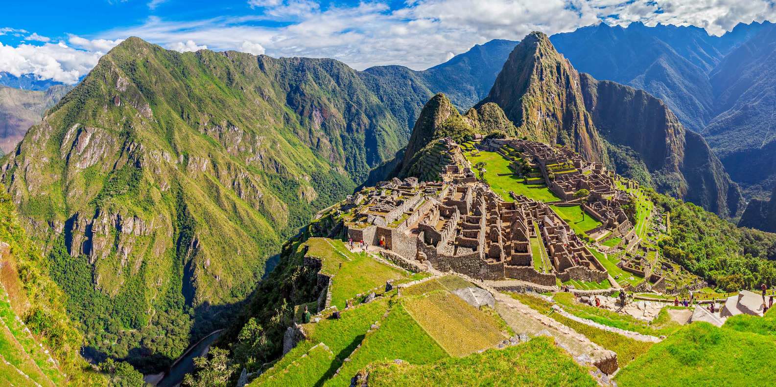 Wide view of Machu Picchu and the surrounding green mountains in Peru
