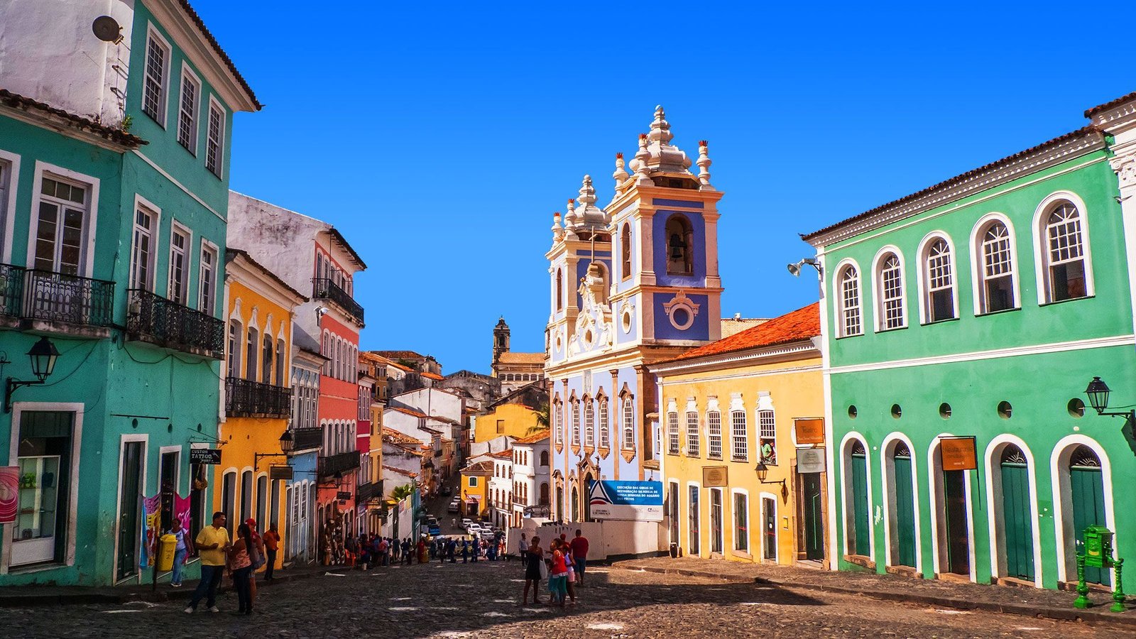 Colorful colonial buildings and a baroque church tower in the Pelourinho historic district of Salvador, Bahia.
