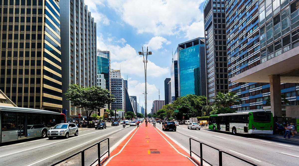 Office towers along Avenida Paulista in São Paulo, with traffic on the avenue below.