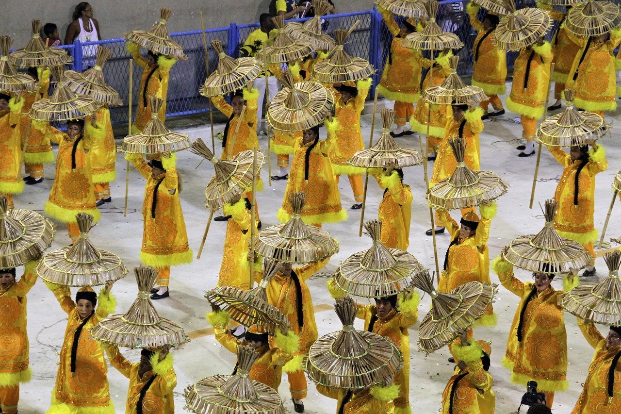 Performers in a Rio Carnival parade wearing yellow costumes.